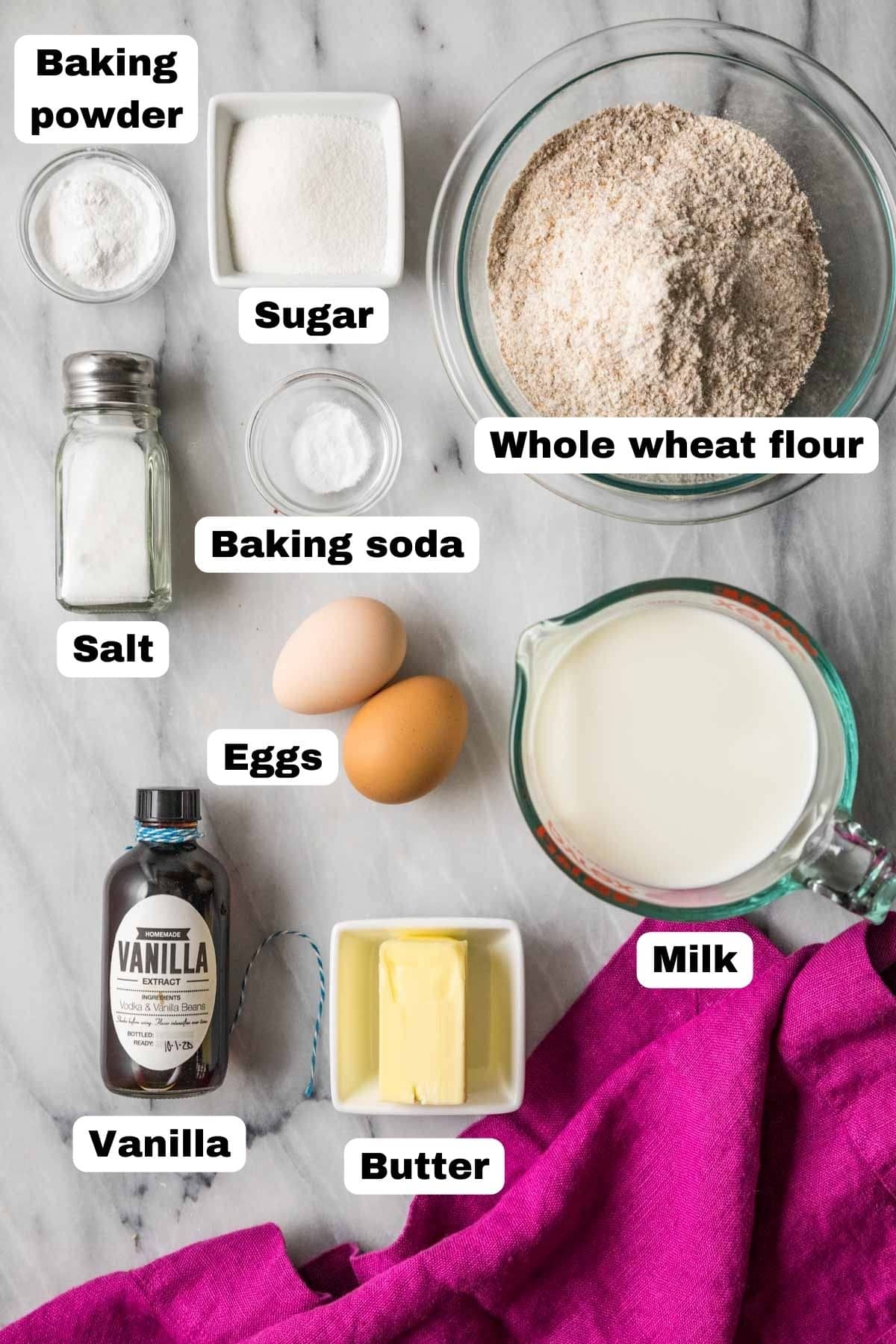 Overhead view of labelled ingredients including whole wheat flour, butter, milk, and more.