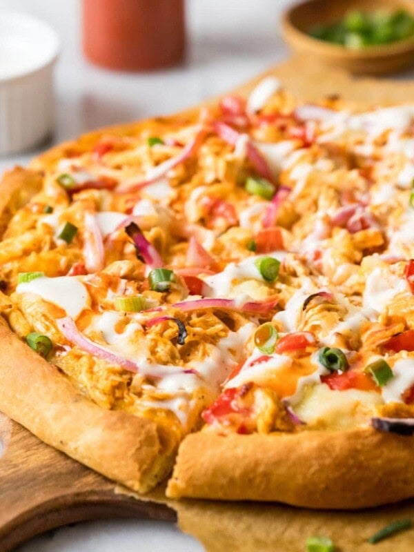 Homemade buffalo chicken on a wood serving platter.