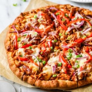 BBQ chicken pizza topped with red onion, bell pepper, and more.