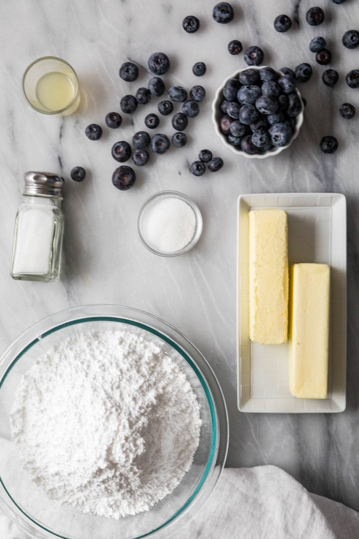 Overhead view of ingredients including blueberries, butter, sugar, and more.