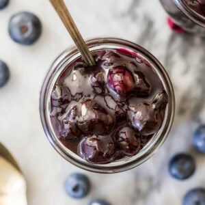 Overhead view of a jar of blueberry sauce.