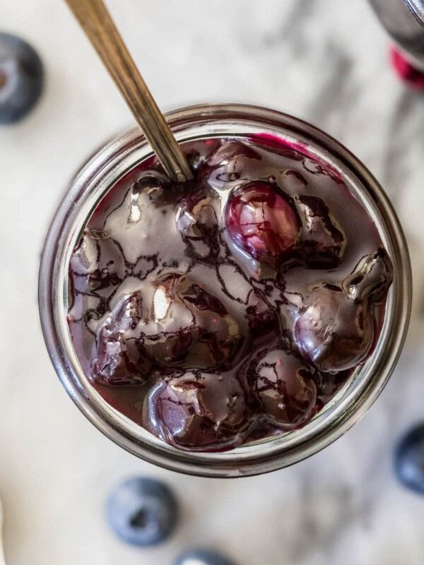 Overhead view of a jar of blueberry sauce.