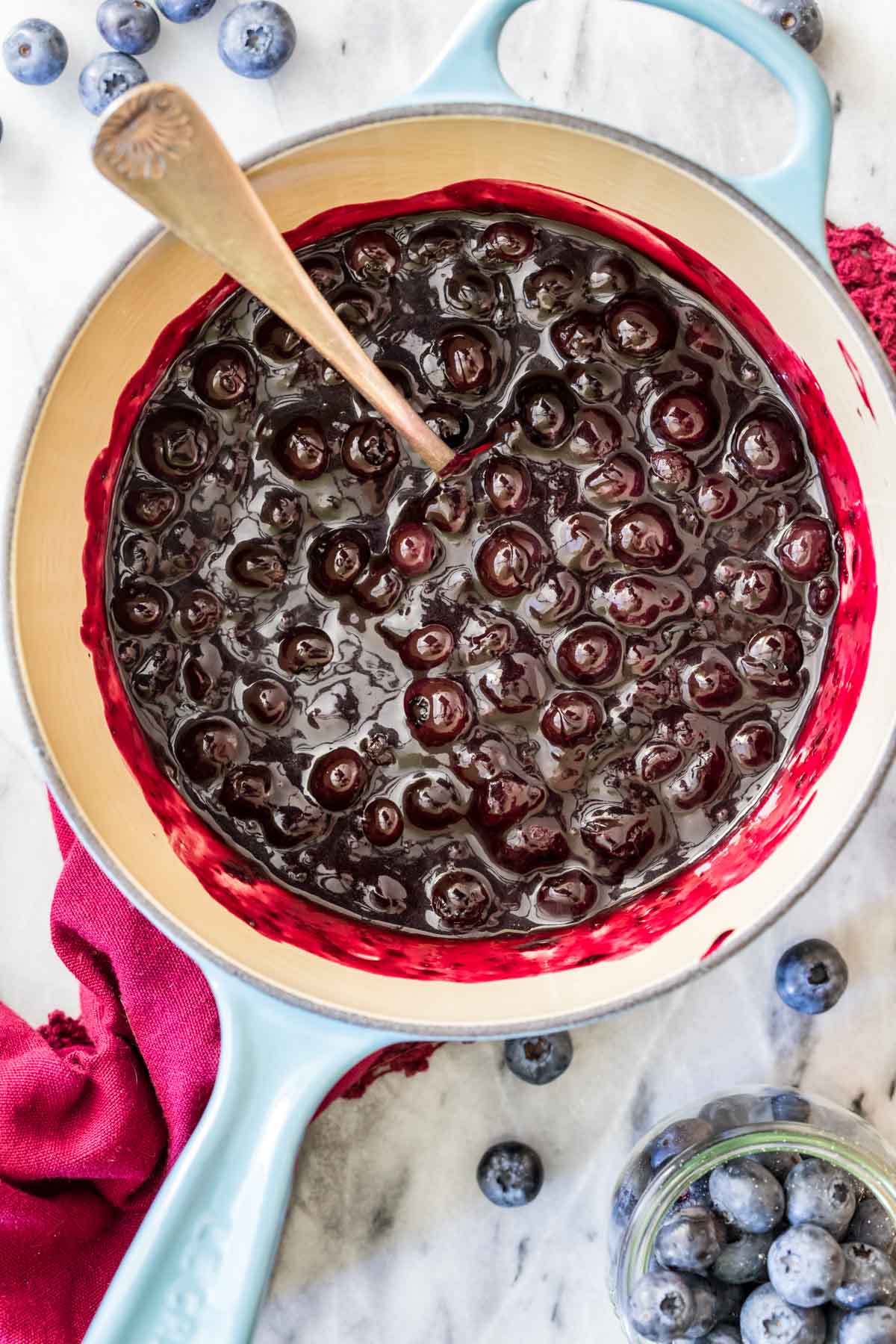 Overhead view of a saucepan with a blueberry compote inside