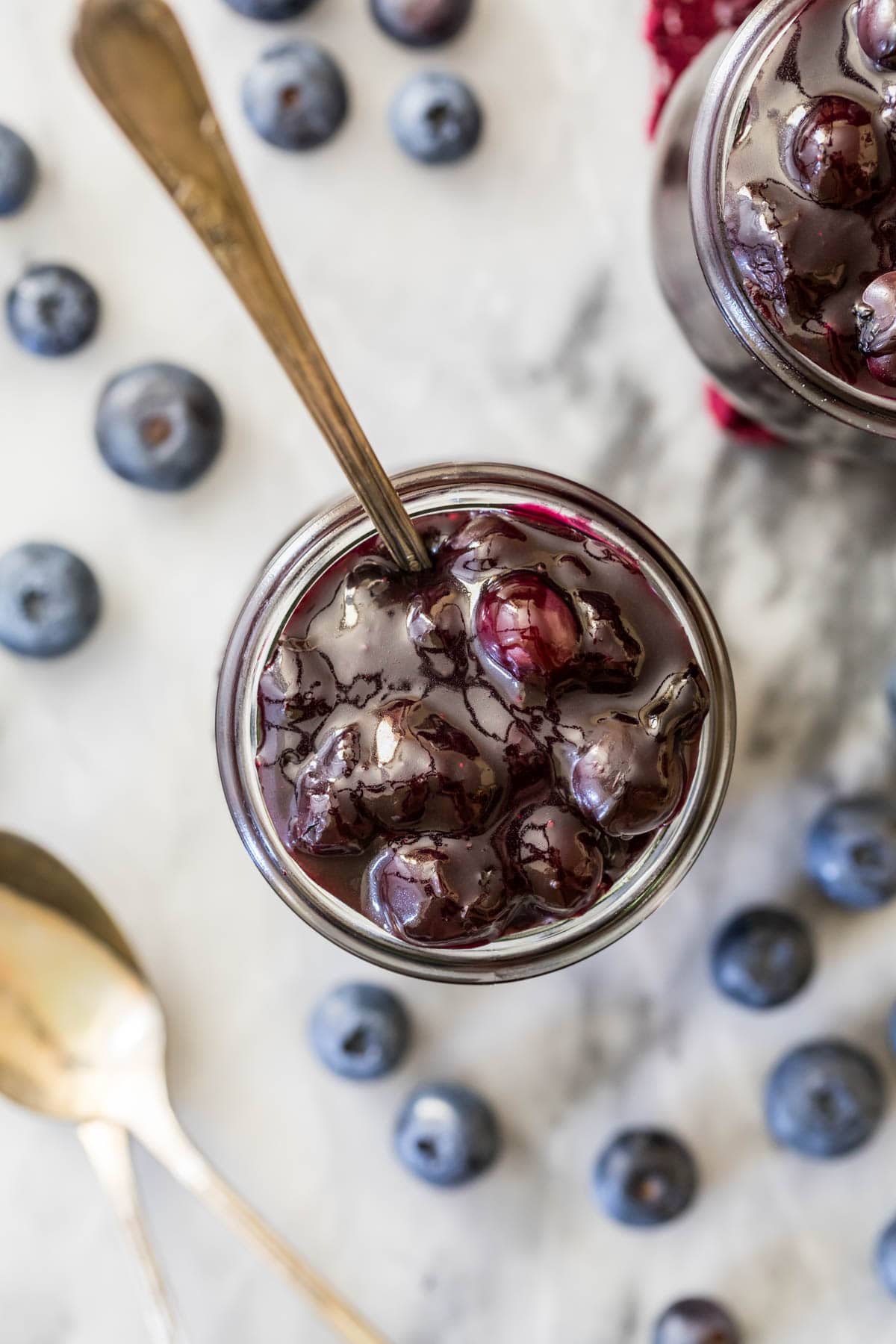 Overhead view of a jar of blueberry sauce.