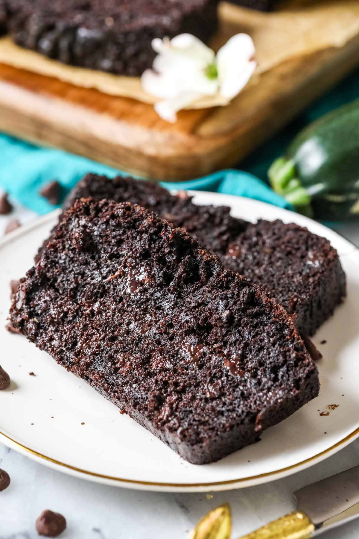 Two slices of chocolate zucchini bread on a plate.