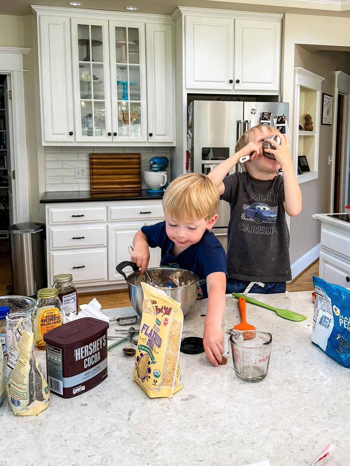 Luke and Rhett making granola in the kitchen