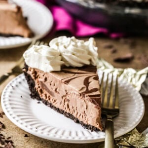 Slice of frozen mudslide pie on a plate with a fork.