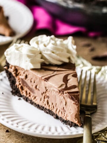 Slice of frozen mudslide pie on a plate with a fork.