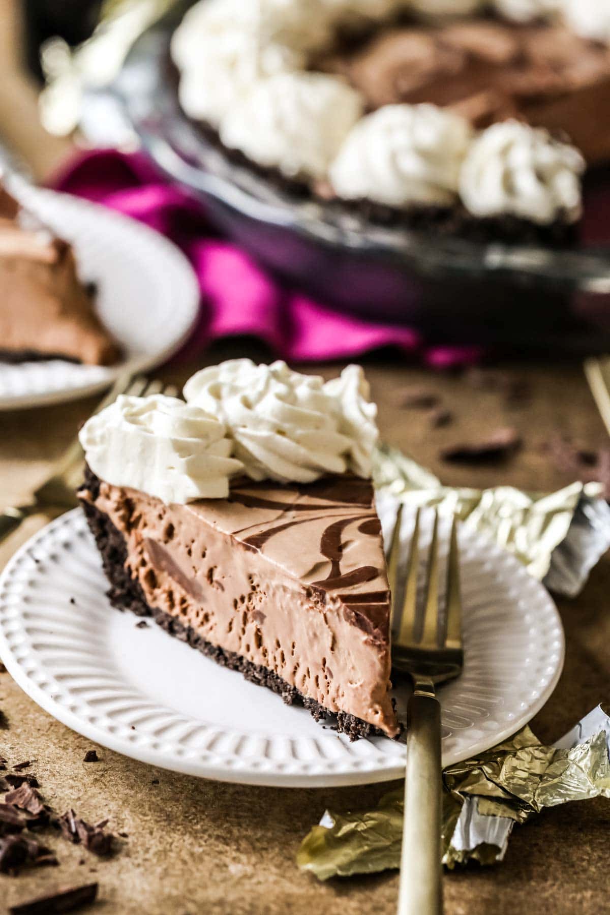 Slice of frozen mudslide pie on a plate with a fork.