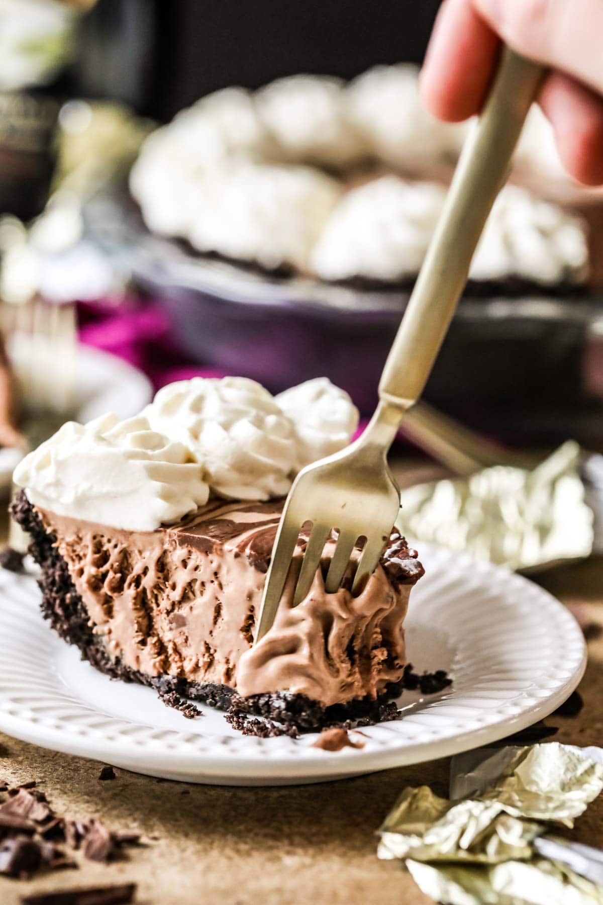 Fork taking a bite from a frozen Mississippi mudslide pie.