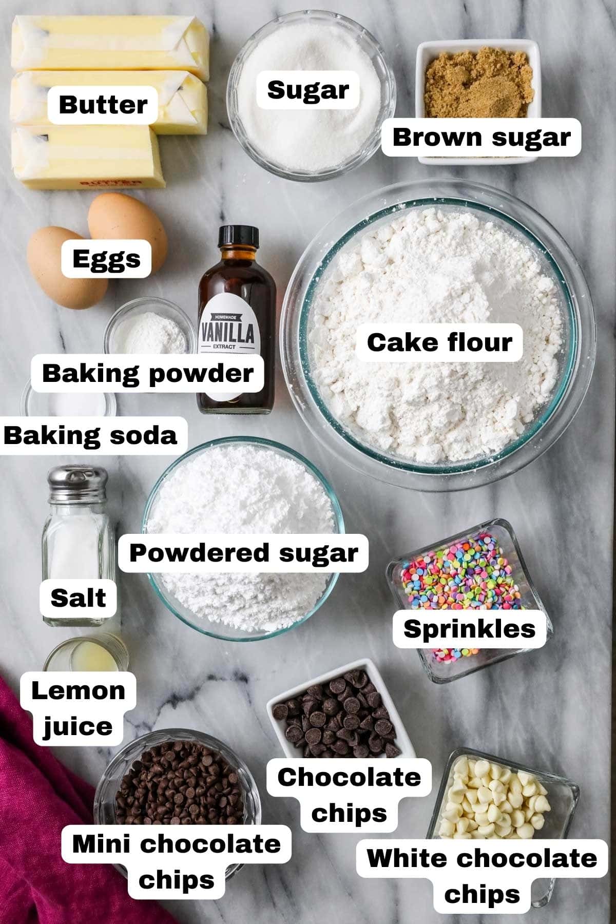 Overhead view of labeled ingredients including sprinkles, chocolate chips, butter, and more.