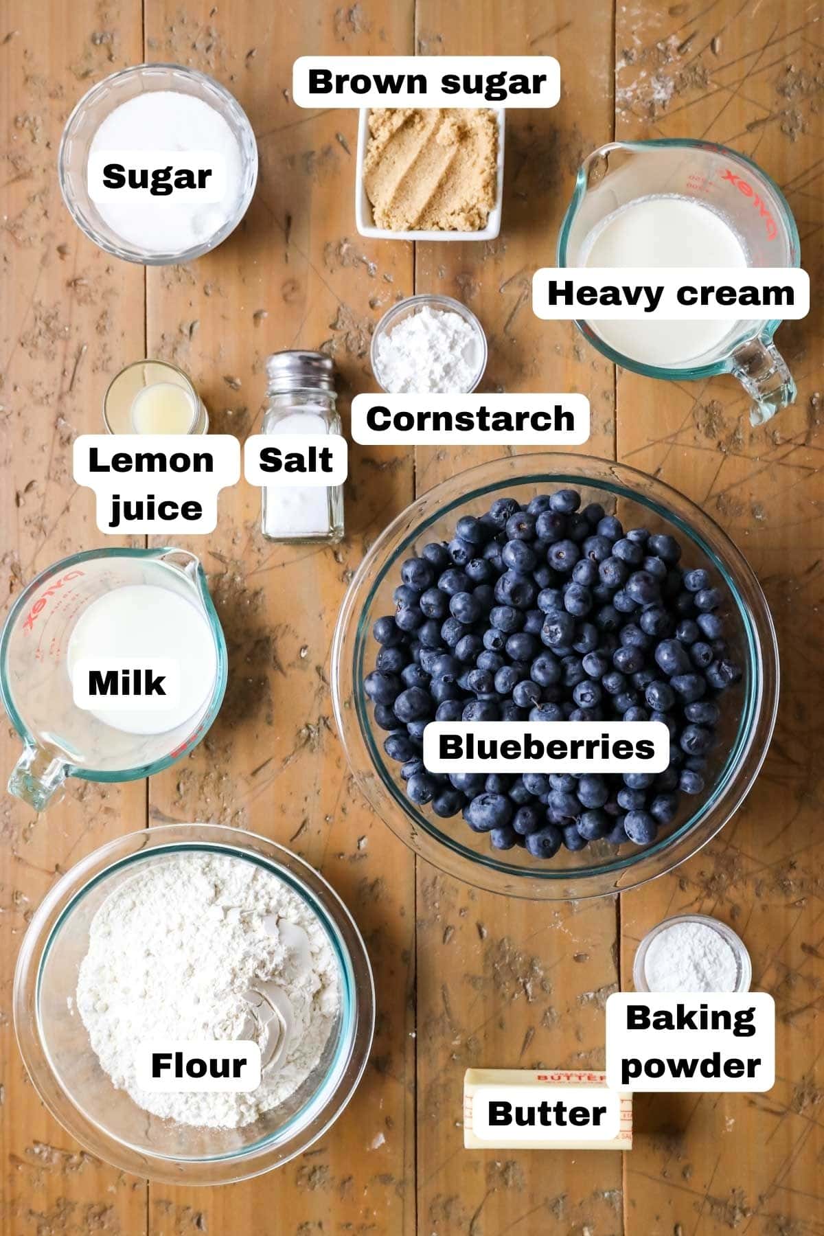 Overhead view of labeled ingredients including blueberries, brown sugar, flour, and more.