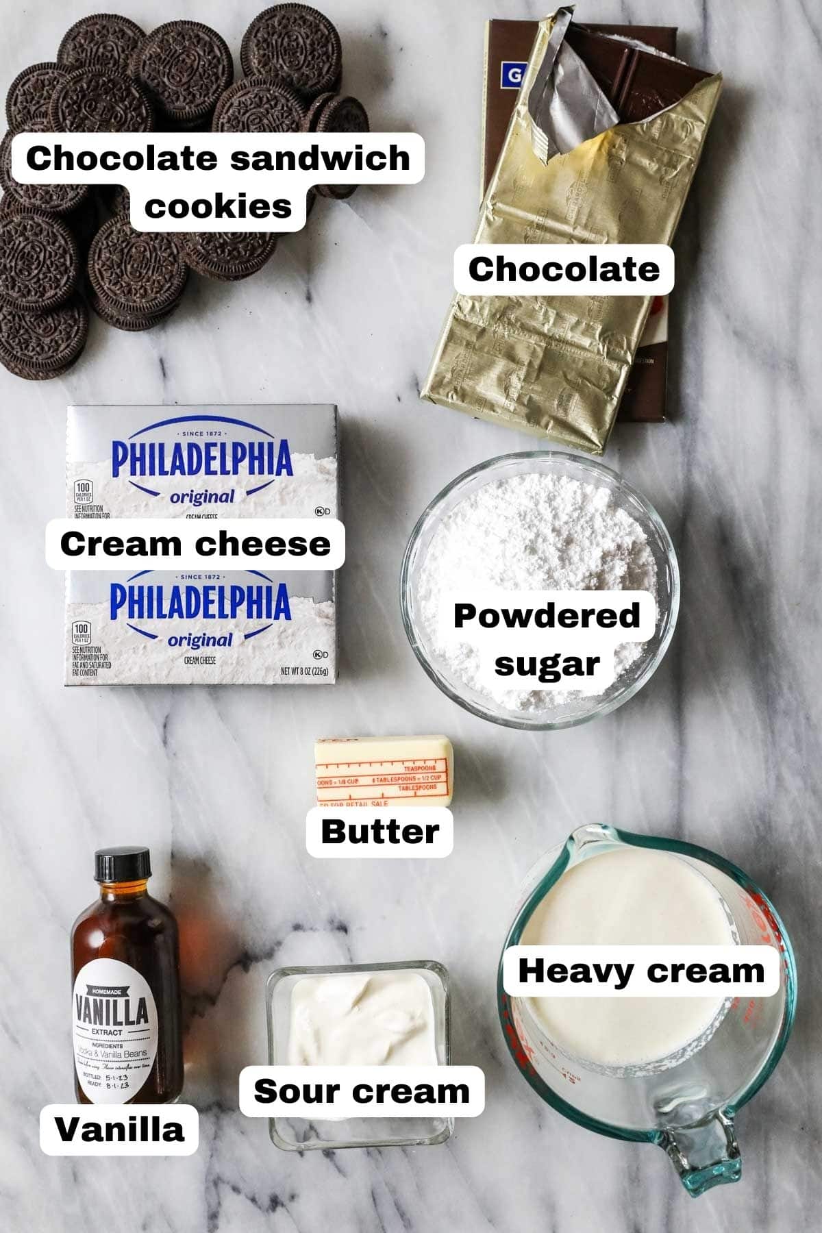 Overhead view of labeled ingredients including Oreo cookies, cream cheese, heavy cream, and more.