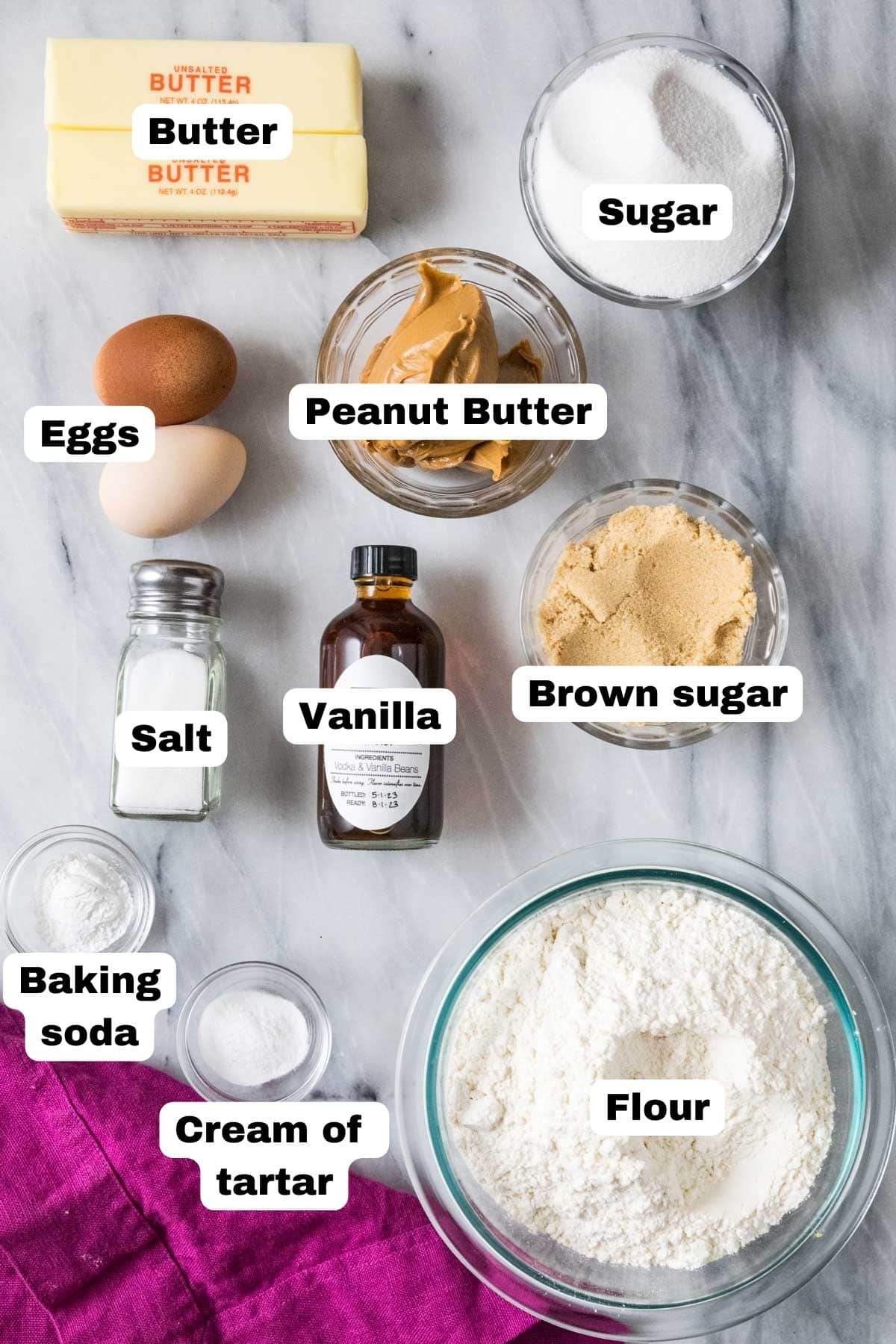 Overhead view of labelled ingredients including peanut butter, cream of tartar, cinnamon, and more.