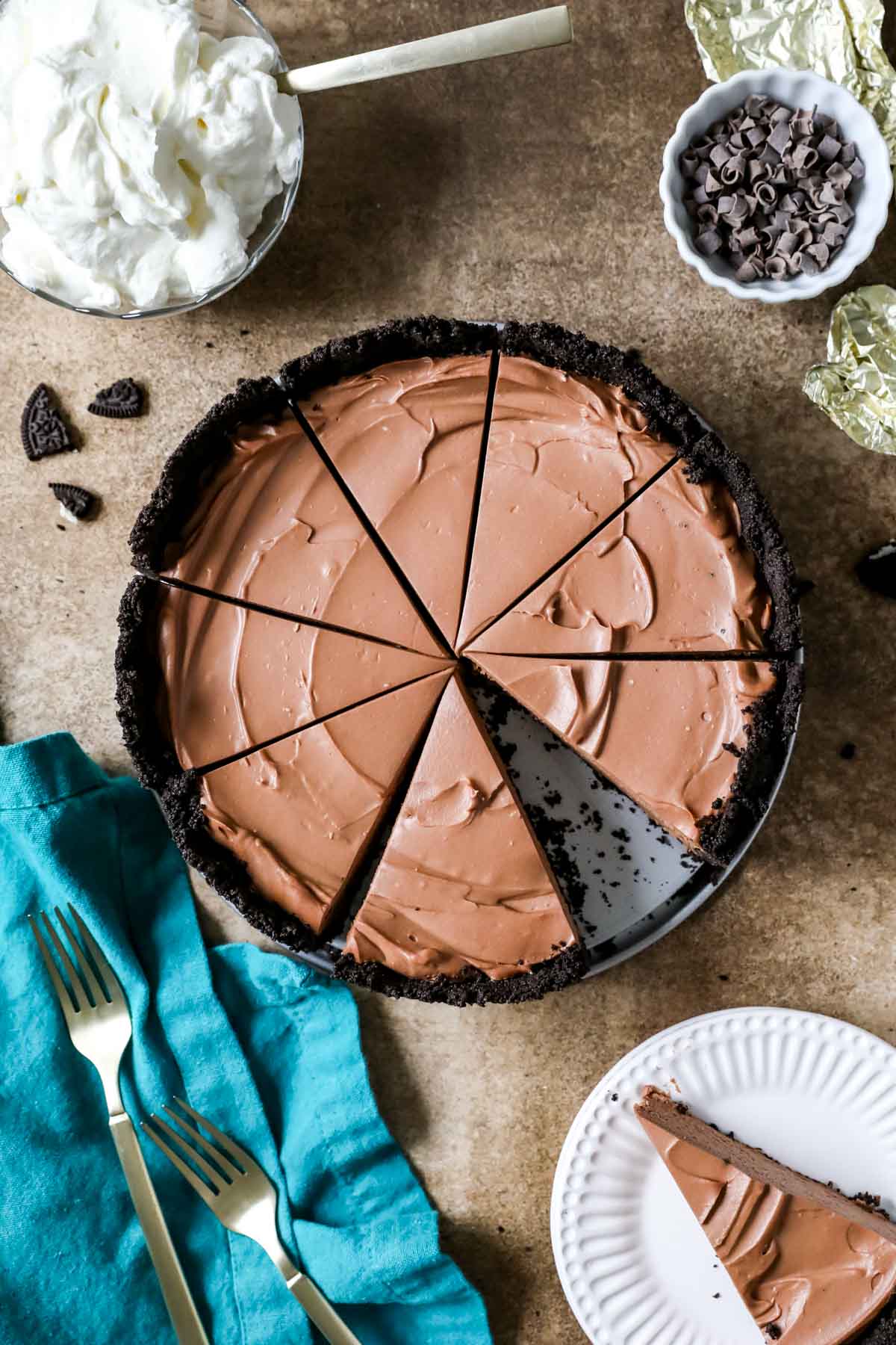 Overhead view of a chocolate no-bake cheesecake that's been cut into slices.