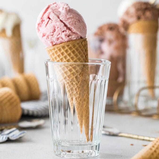 Ice cream cone with a scoop of homemade strawberry ice cream.