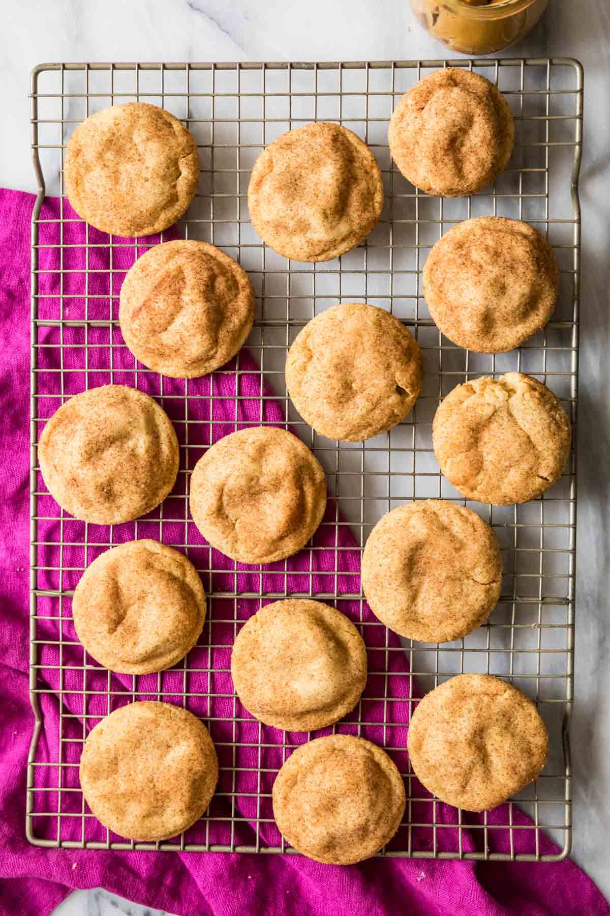 Overhead view of peanut butter snickerdoodles on a cooling rack.