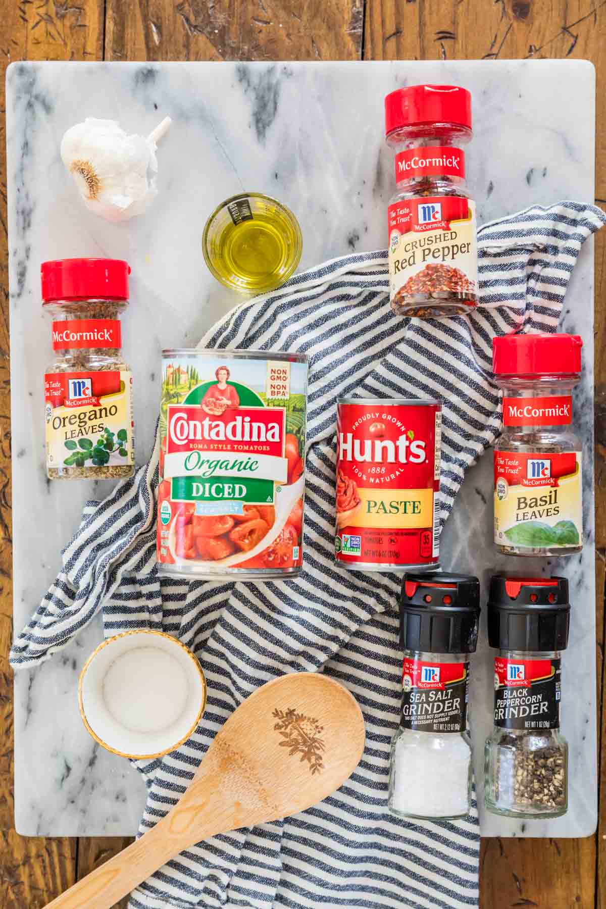 Overhead view of ingredients including tomatoes, tomato paste, herbs, and more.