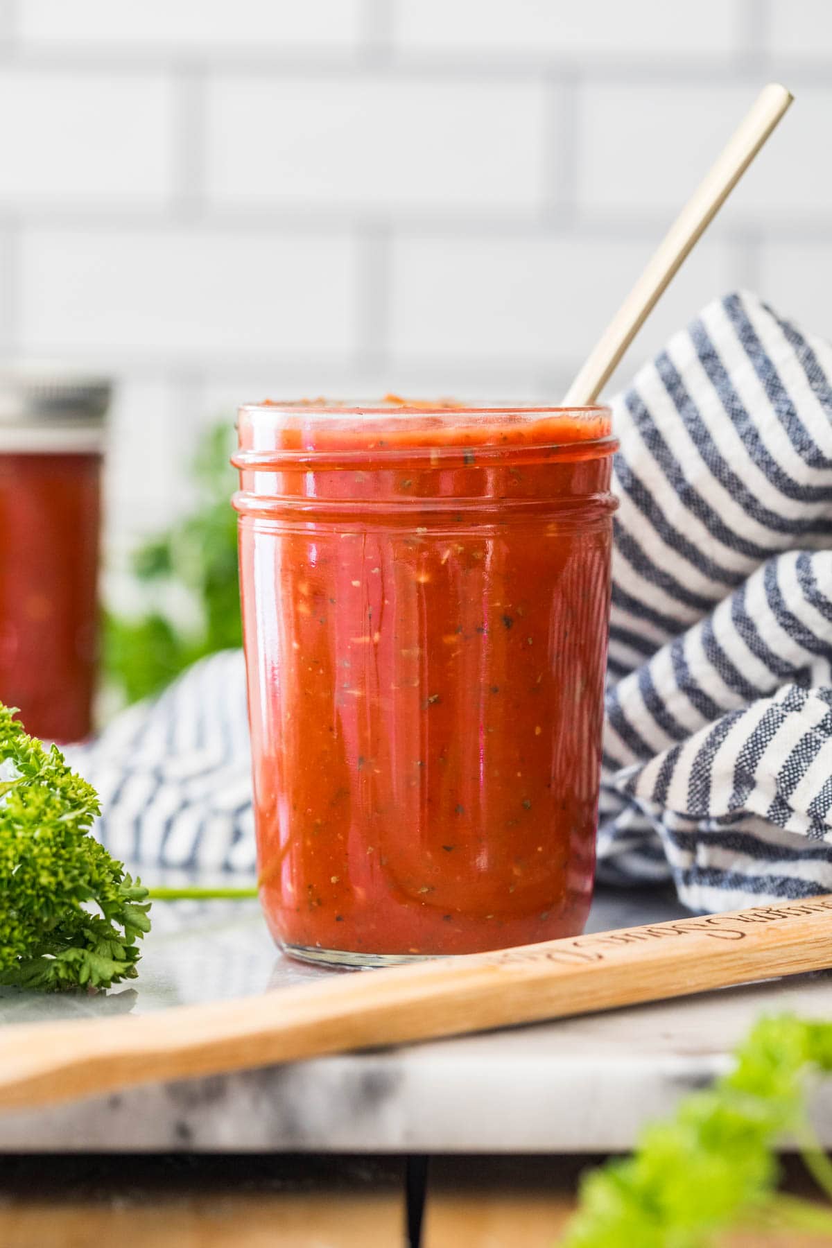 Jar of red tomato sauce used for pizza.