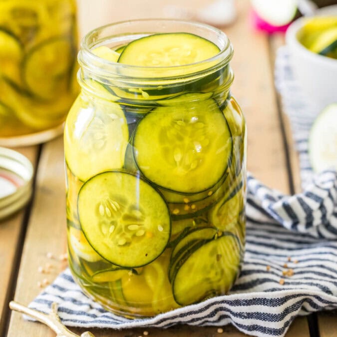 Jar of refrigerator pickles on a striped towel.