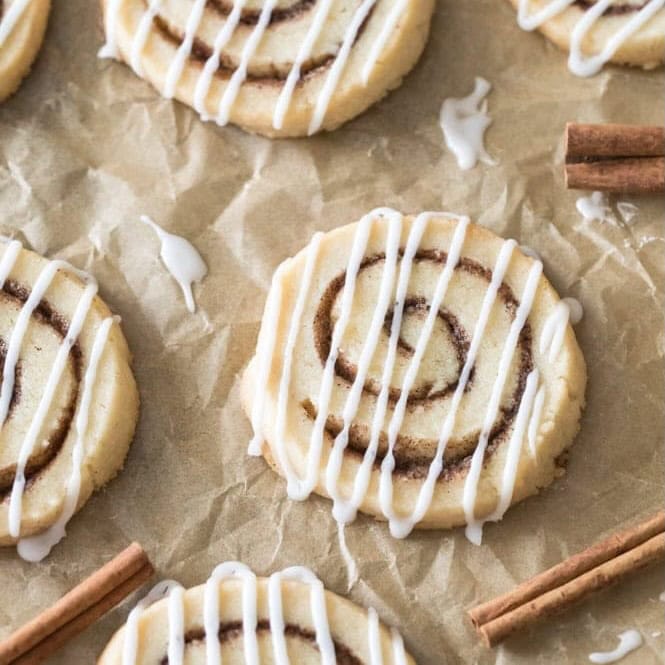Overhead view of cinnamon roll cookies drizzled with icing.