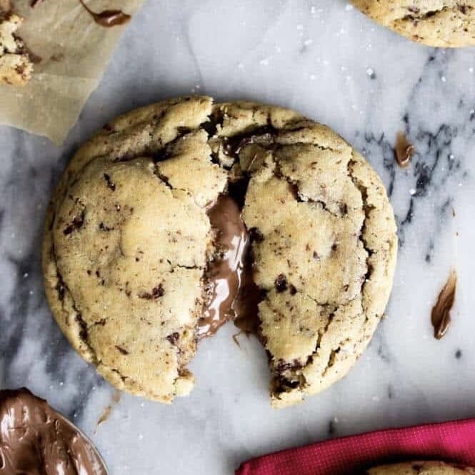 Overhead view of a nutella stuffed cookie that's been broken in half to show the gooey center.