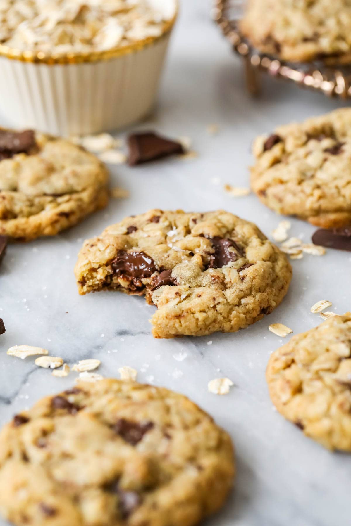 Close-up view of a brown butter oatmeal chocolate chip cookie with a bite missing.