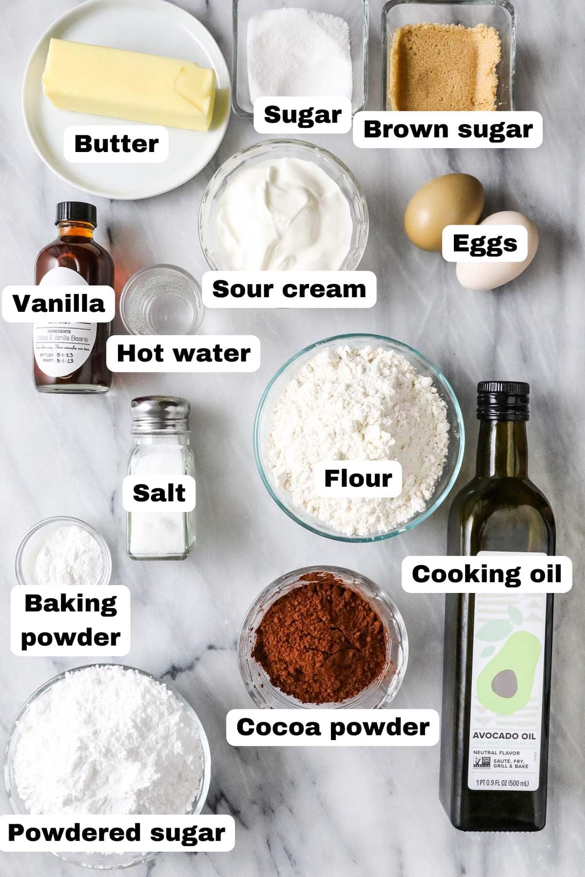 Overhead view of ingredients including cocoa powder, sour cream, vanilla, and more.