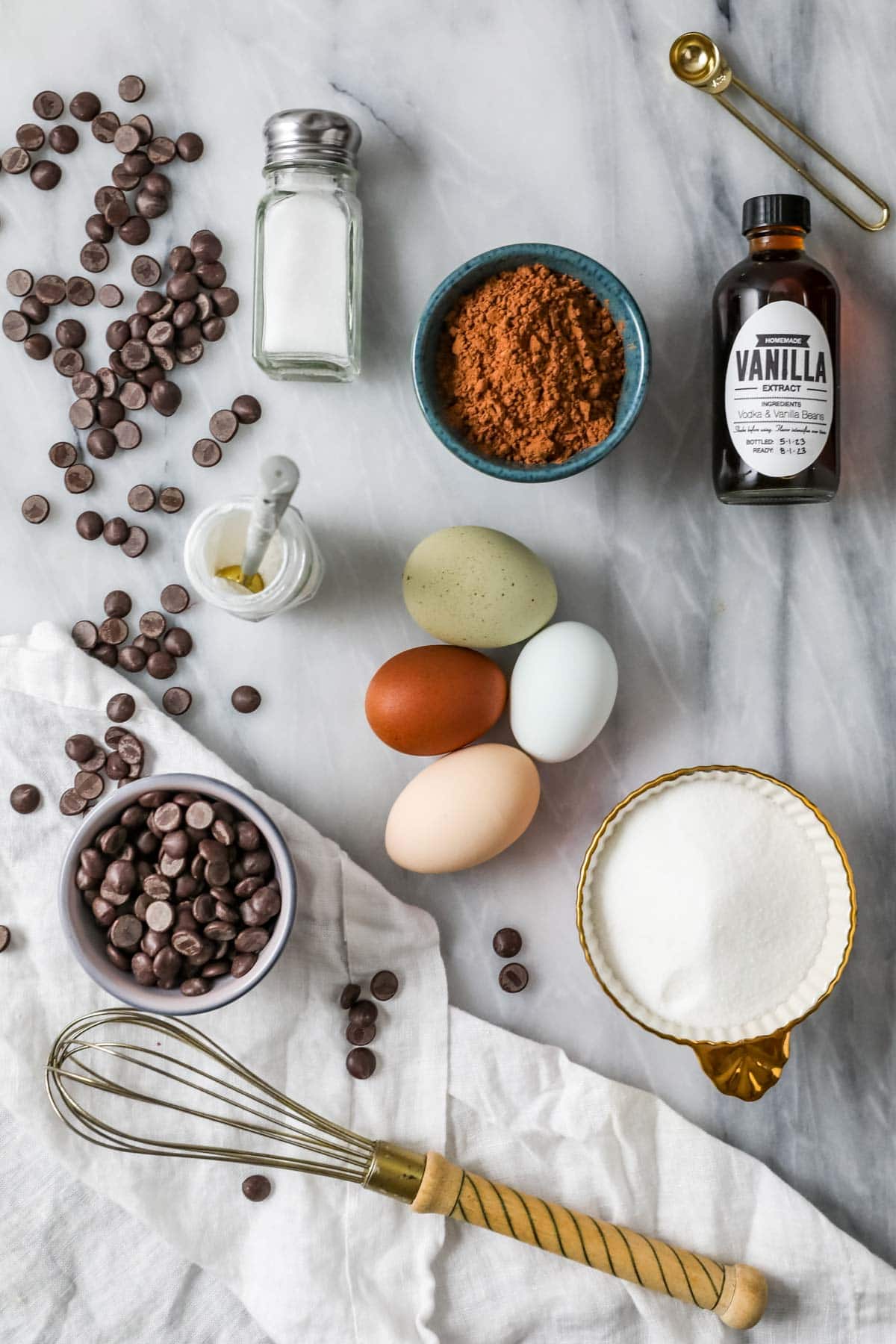 Overhead view of ingredients including chocolate, egg whites, cocoa powder, and more.