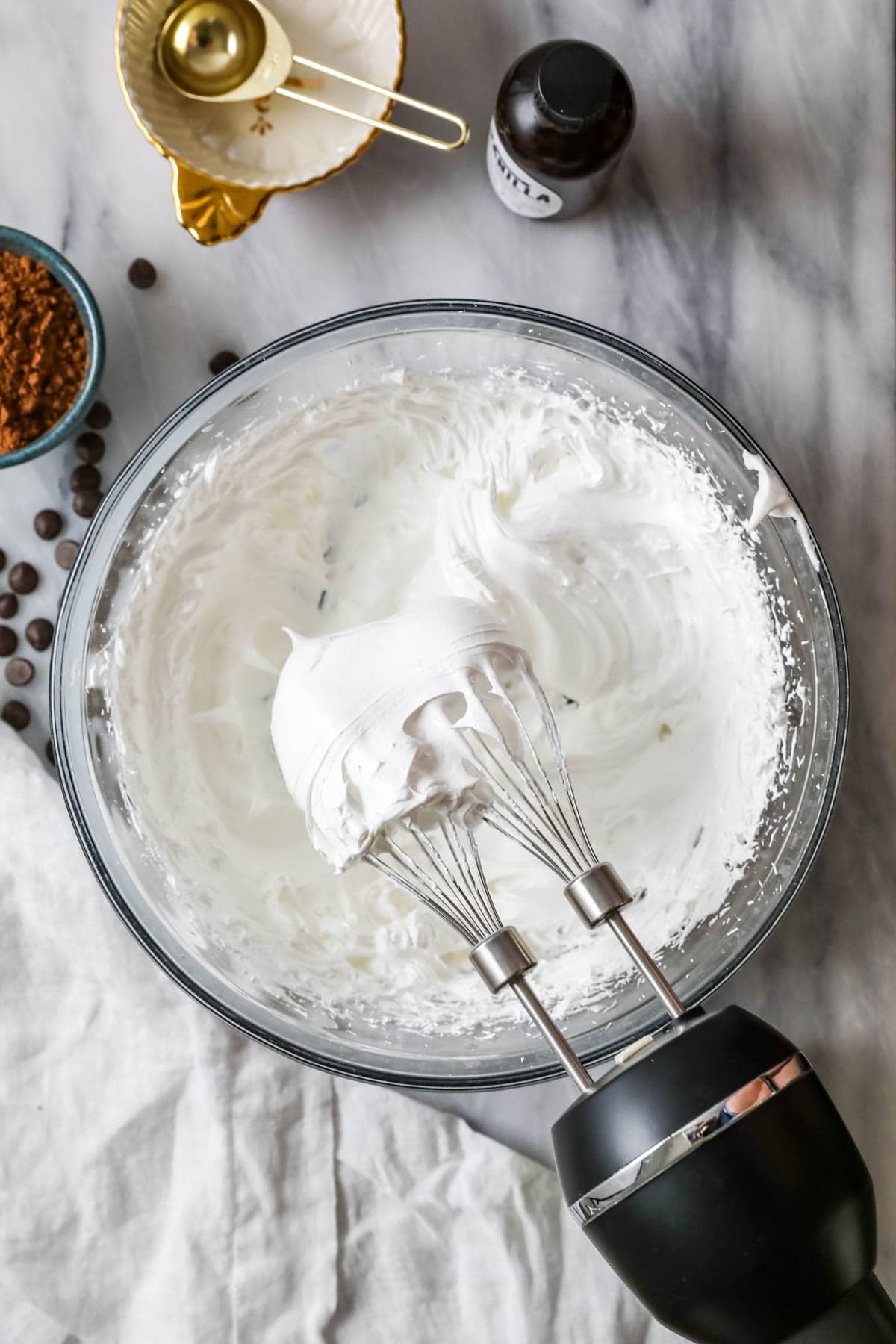 Overhead view of a bowl of egg whites whipped to stiff peaks.