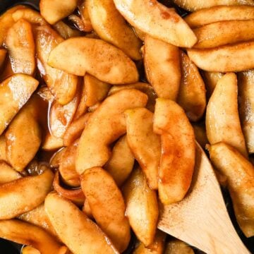 Overhead view of fried apples in a skillet.