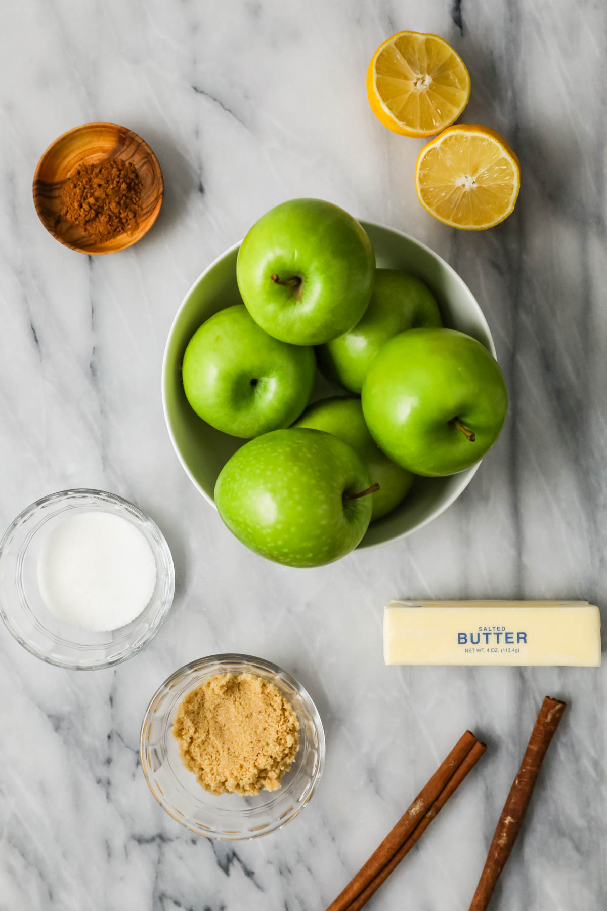 Overhead view of ingredients including apples, butter, sugar, and more.