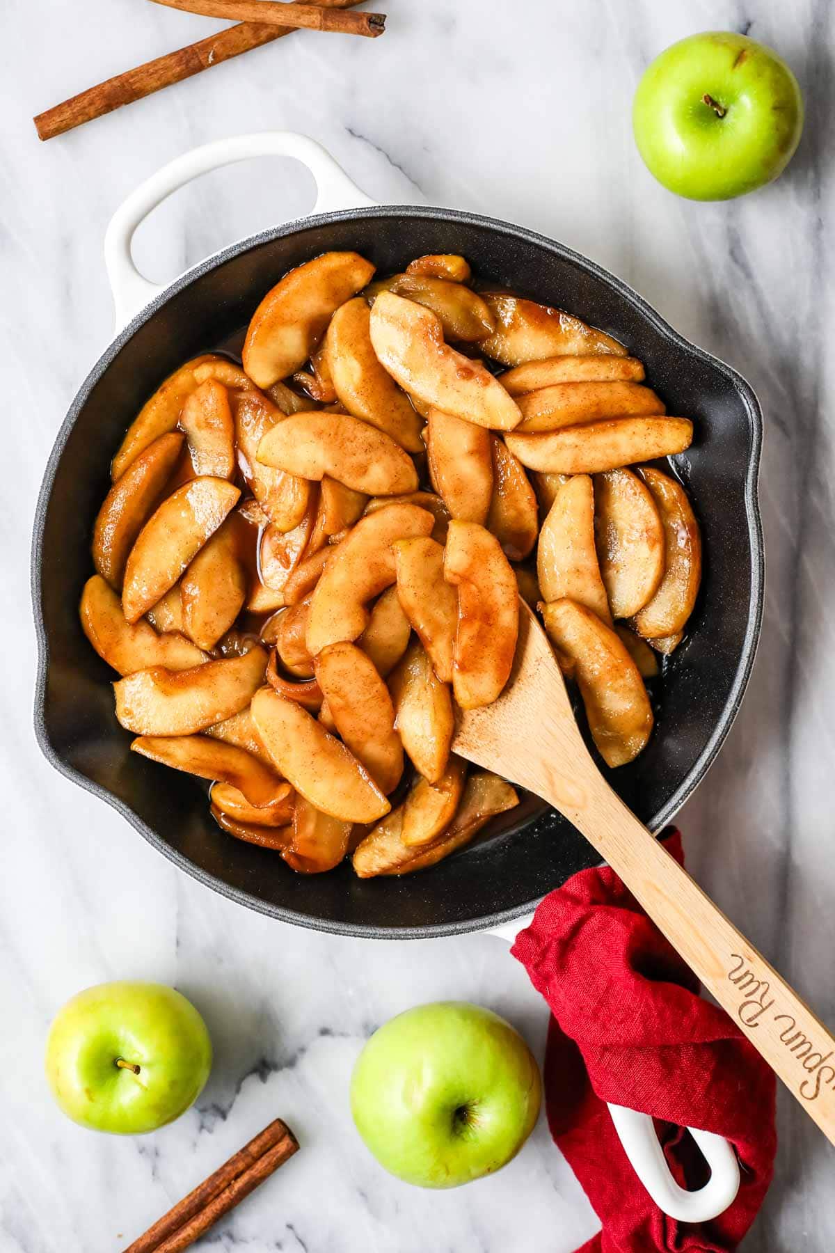 Overhead view of fried apples in a skillet.