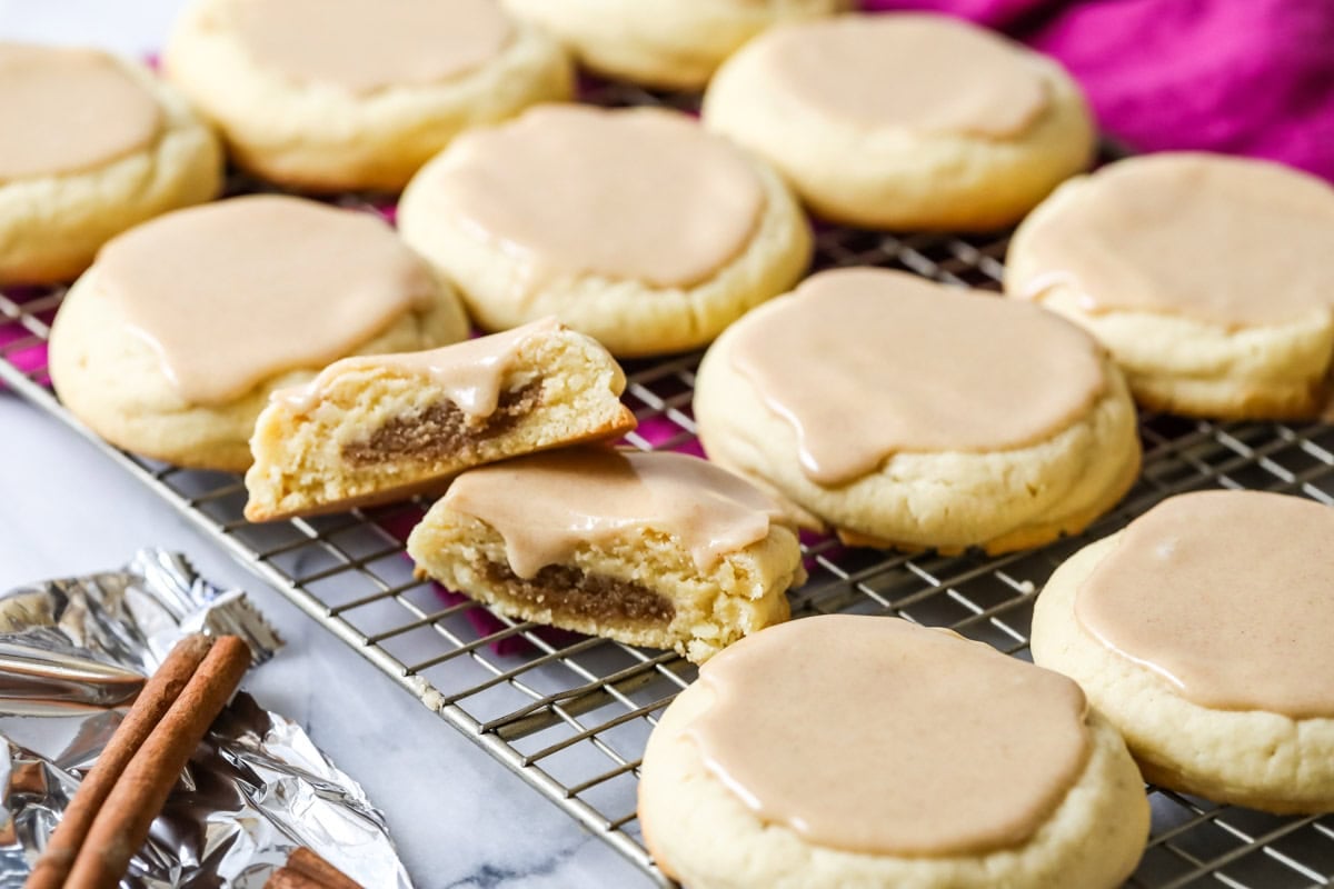 Pop tart cookies filled with a brown sugar cinnamon filling and topped with a cinnamon glaze on a cooling rack.