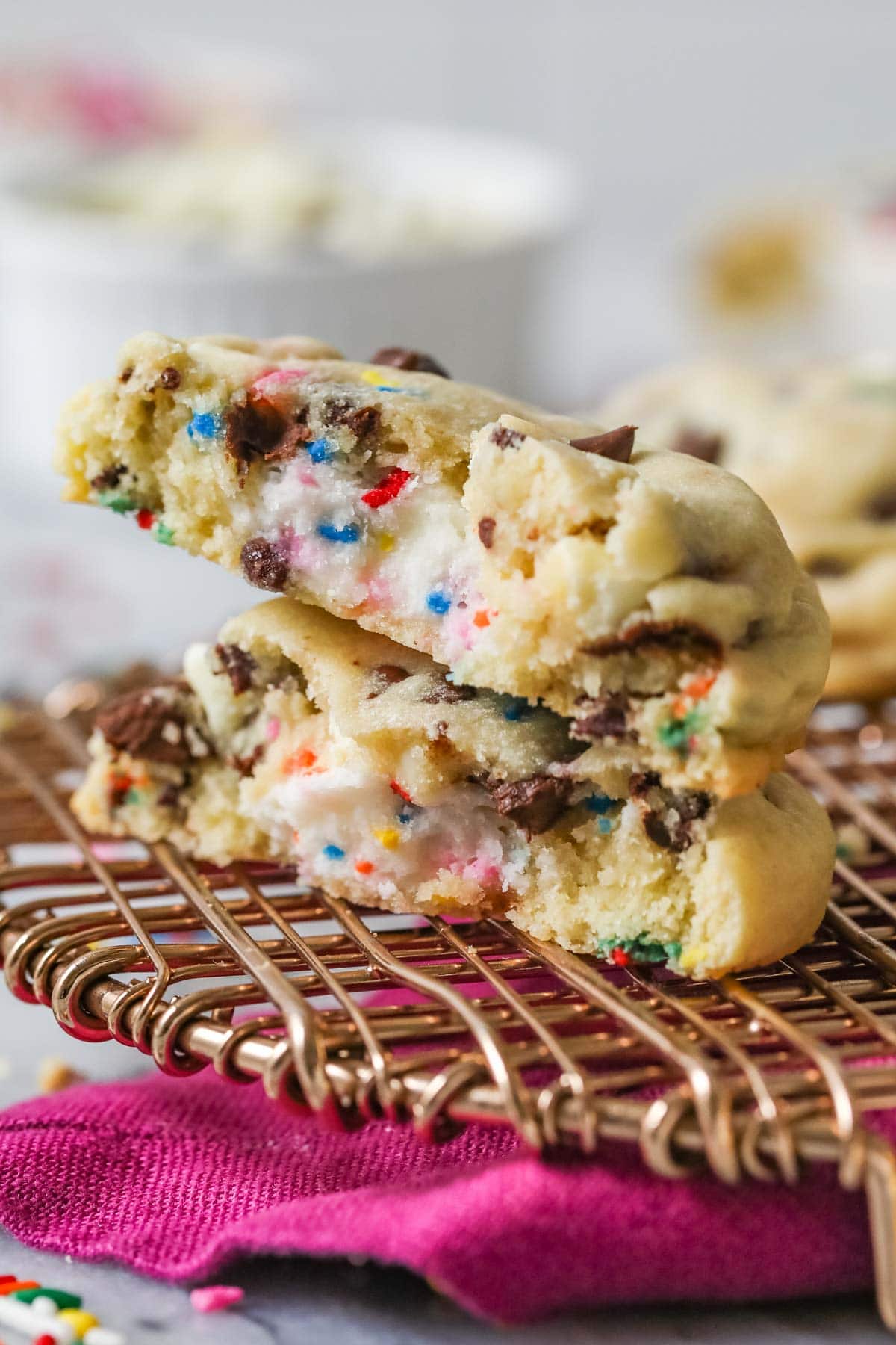 Two halves of a frosting filled cookie stacked on top of each other.