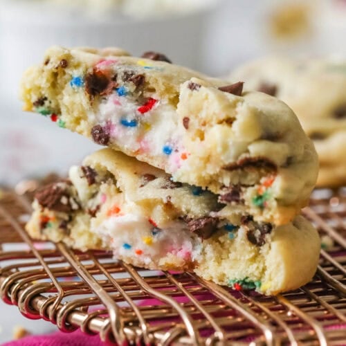 Two halves of a frosting filled cookie stacked on top of each other.