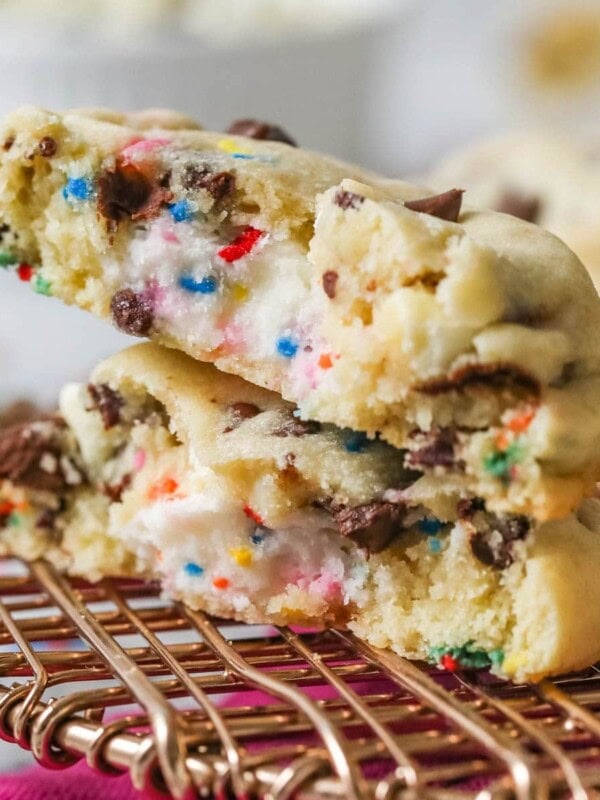 Two halves of a frosting filled cookie stacked on top of each other.