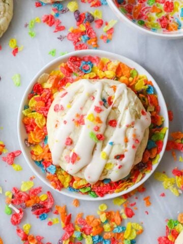 Overhead view of a Fruity Pebbles cookie sitting in a bowl of cereal.