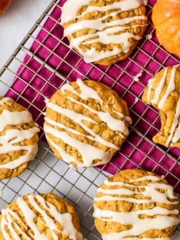 Overhead view of pumpkin oatmeal cookies topped with a brown sugar drizzle.