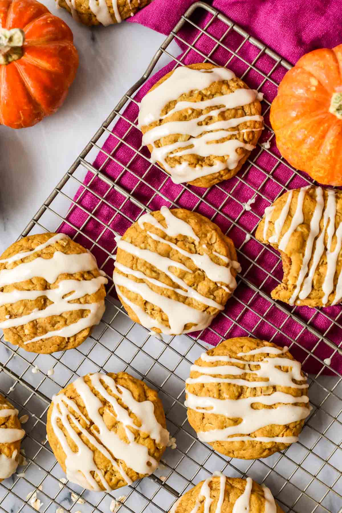 Overhead view of pumpkin oatmeal cookies topped with a brown sugar drizzle.