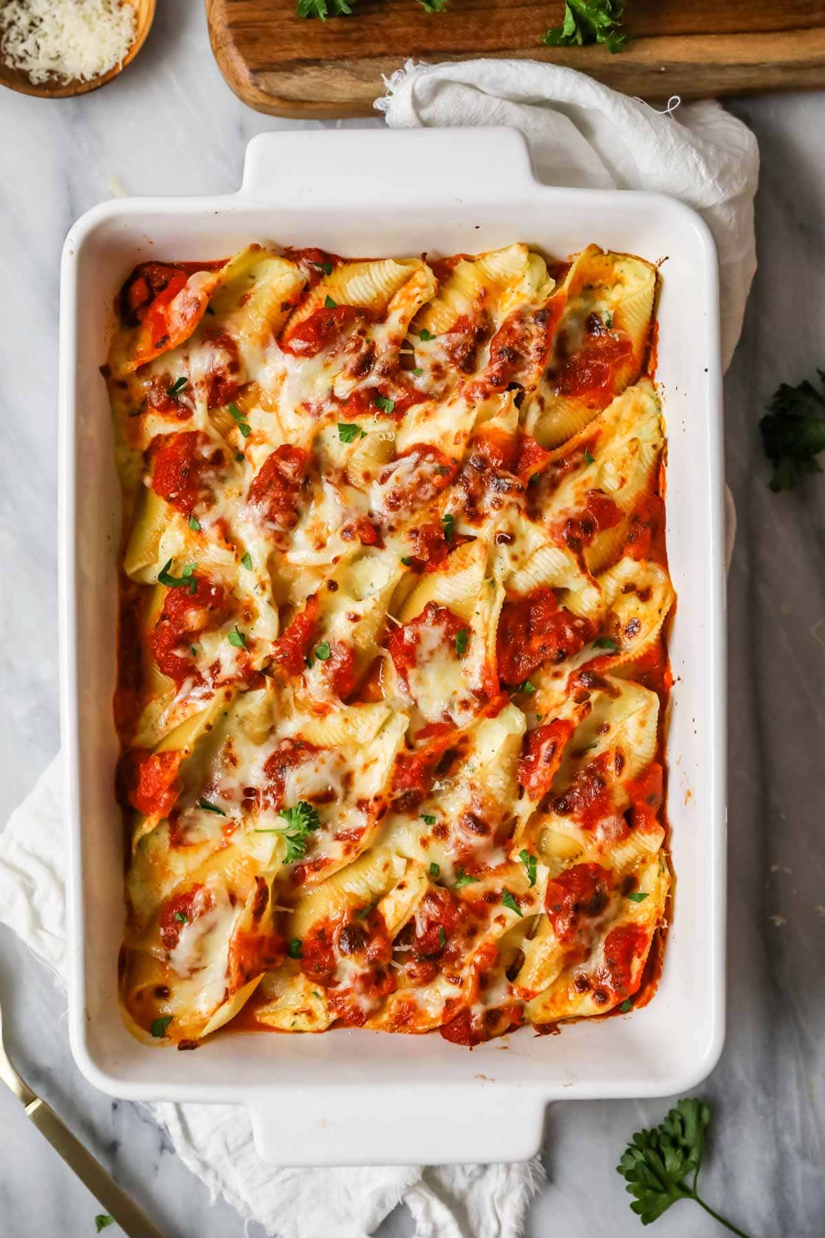 Overhead view of a pan of stuffed shells after baking.