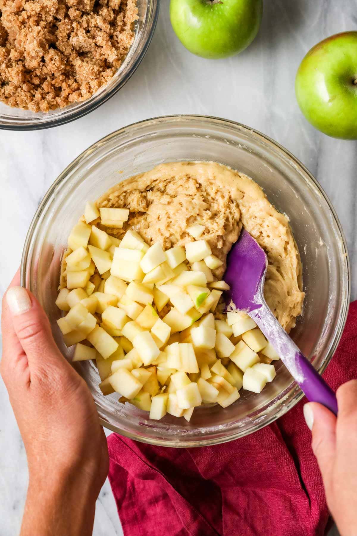 Mixing apples into apple crumb cake batter