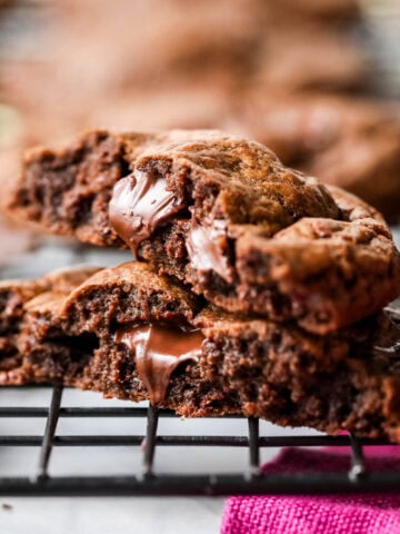 Two halves of a chocolate cookie stacked on top of each other.