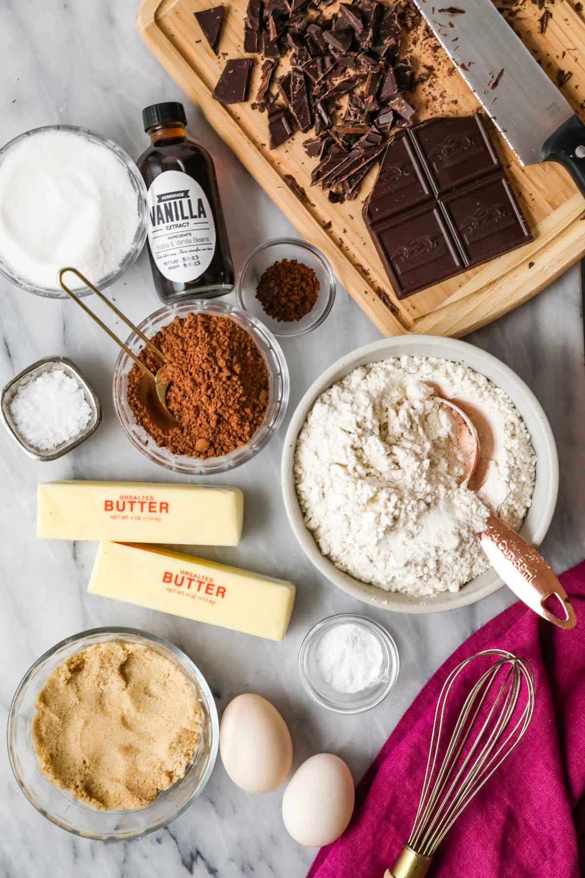 Overhead view of ingredients including chocolate, cocoa powder, brown sugar, and more.