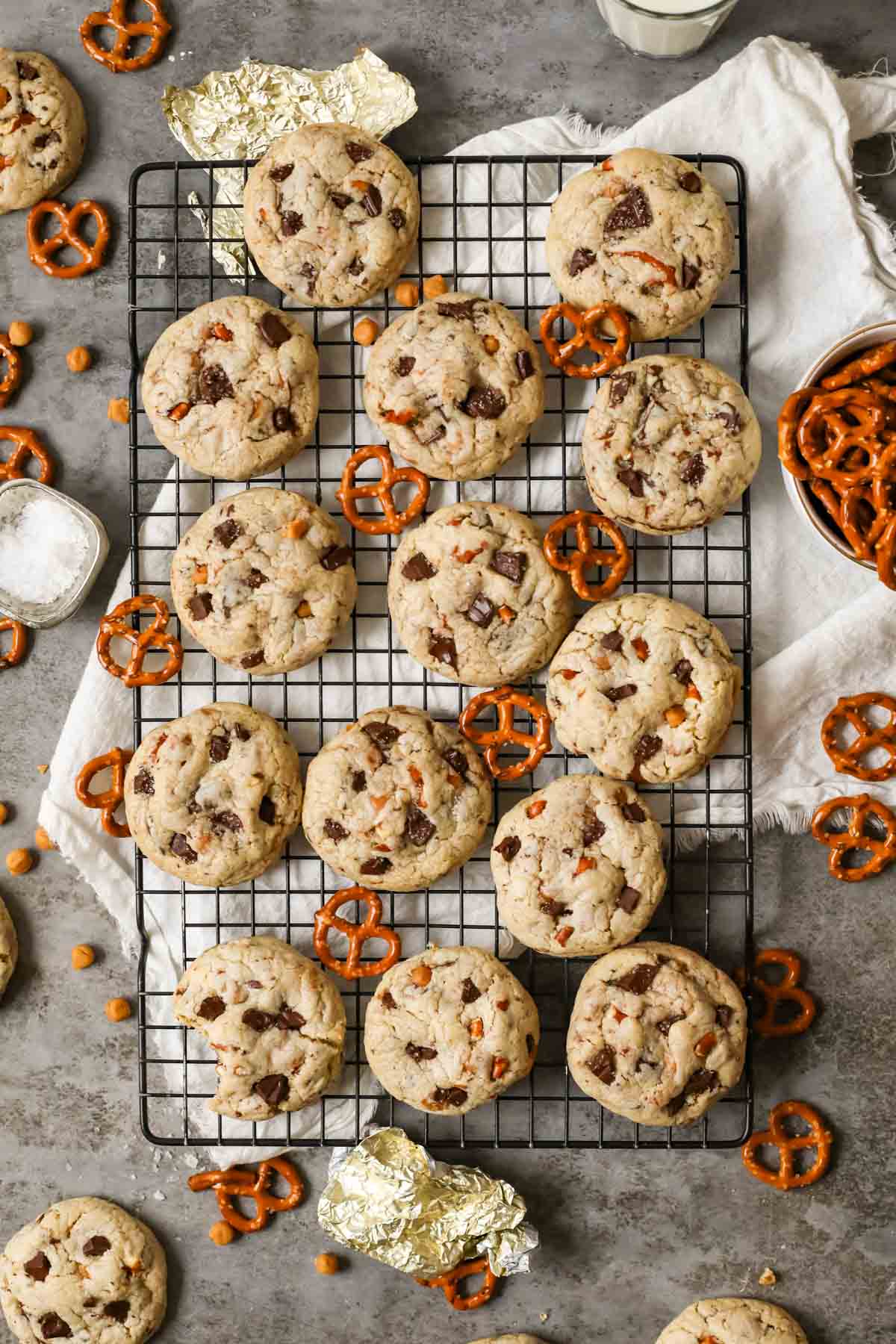 Overhead view of cookies made with pretzel pieces, chocolate, and caramel on a cooling rack.