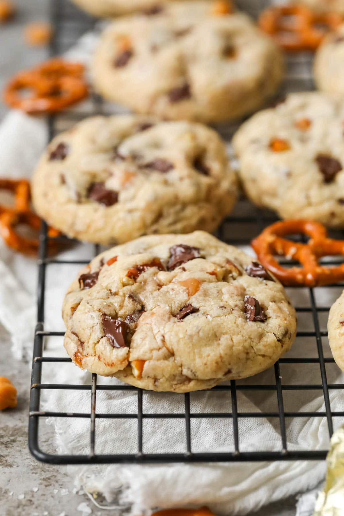 Two cookies made with pretzels, caramel, and chocolate chips.