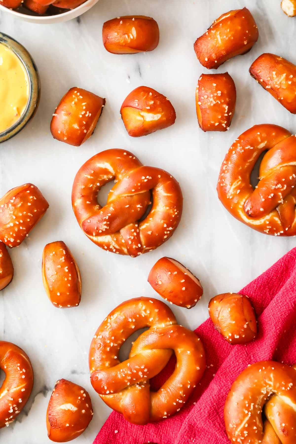 Overhead view of golden brown soft pretzels and pretzel bites made with sourdough starter.