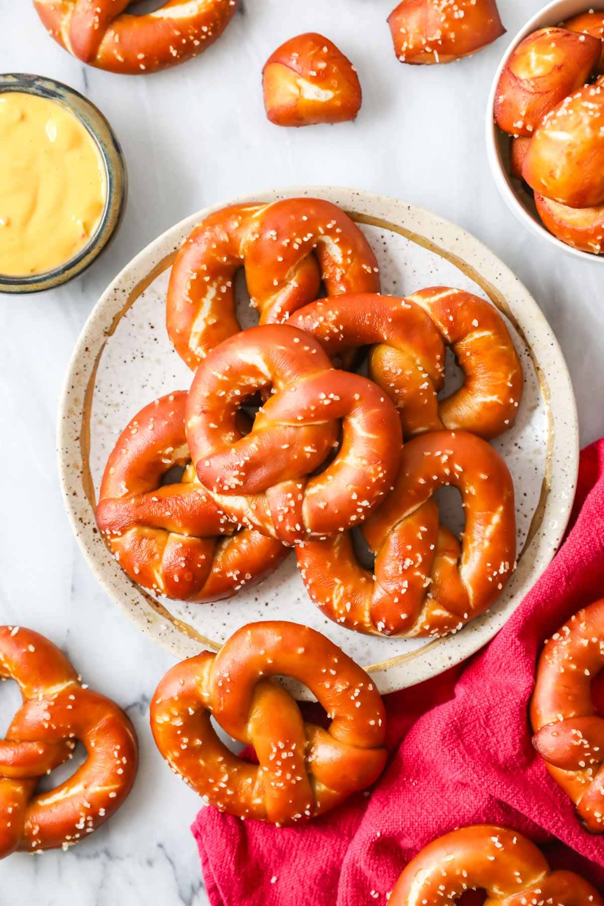 Overhead view of a plate of golden brown soft pretzels made with sourdough starter.