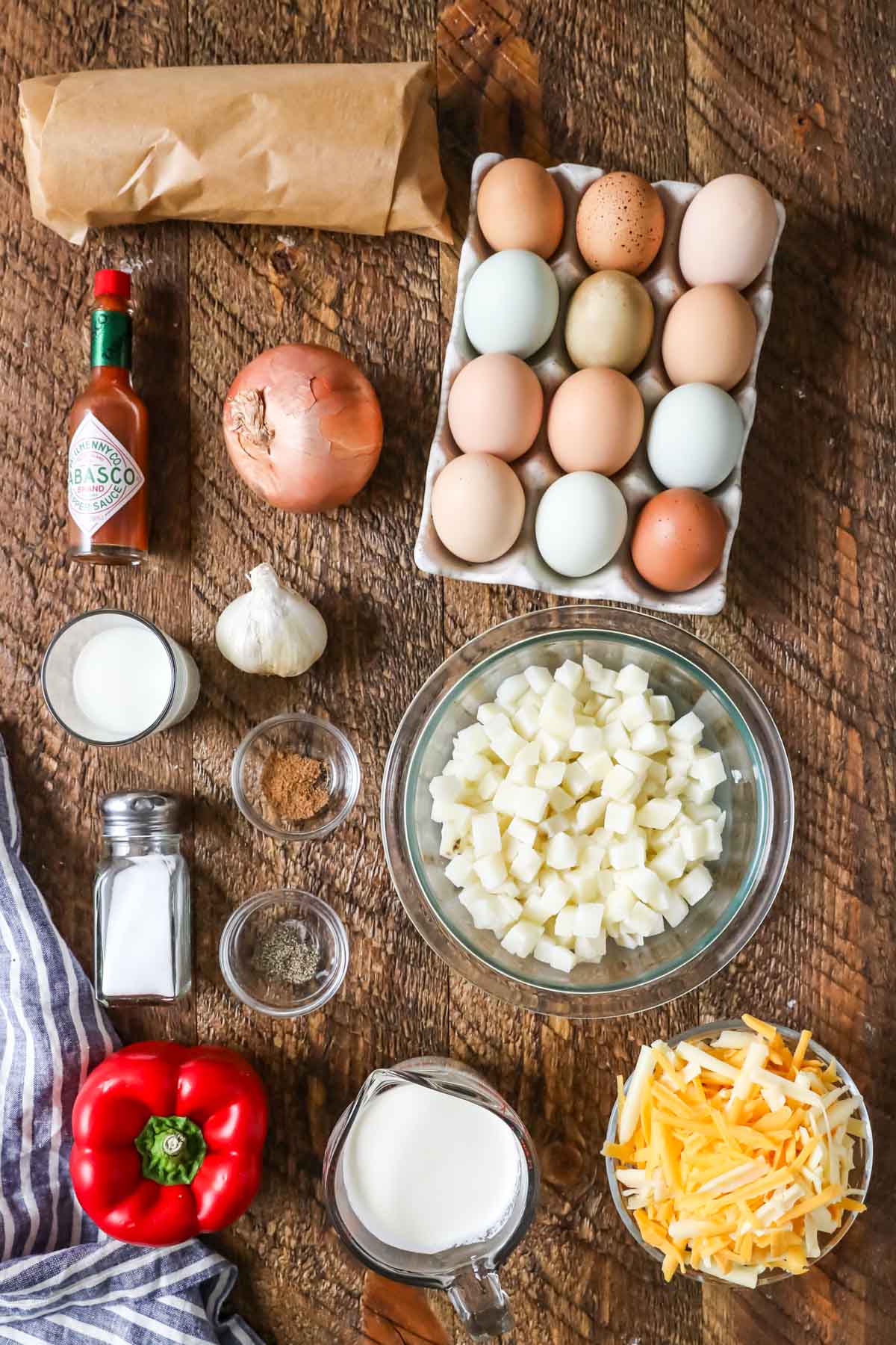 Overhead view of ingredients including eggs, hash browns, tabasco, and more.