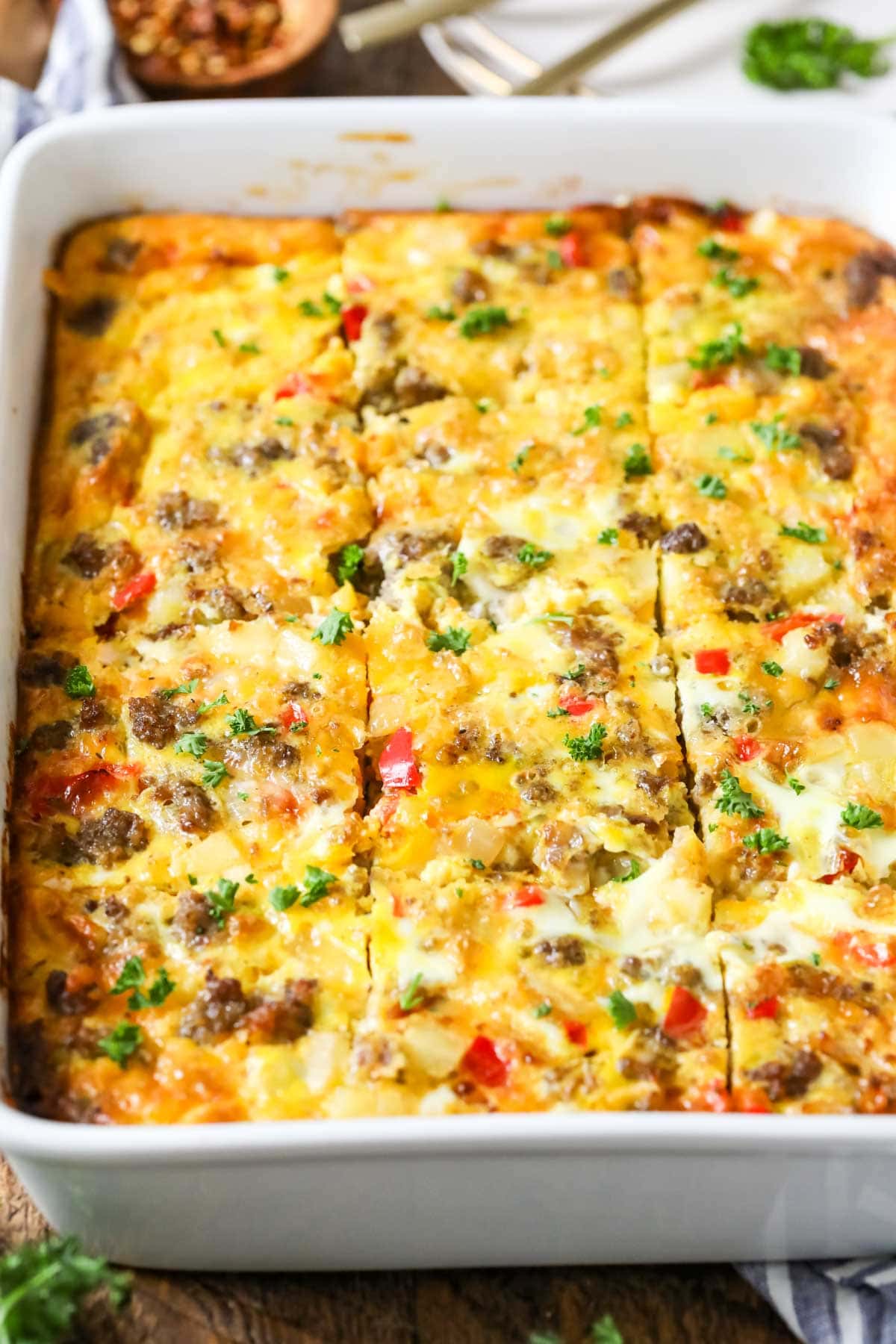 Close-up view of a breakfast casserole that's been cut into squares.